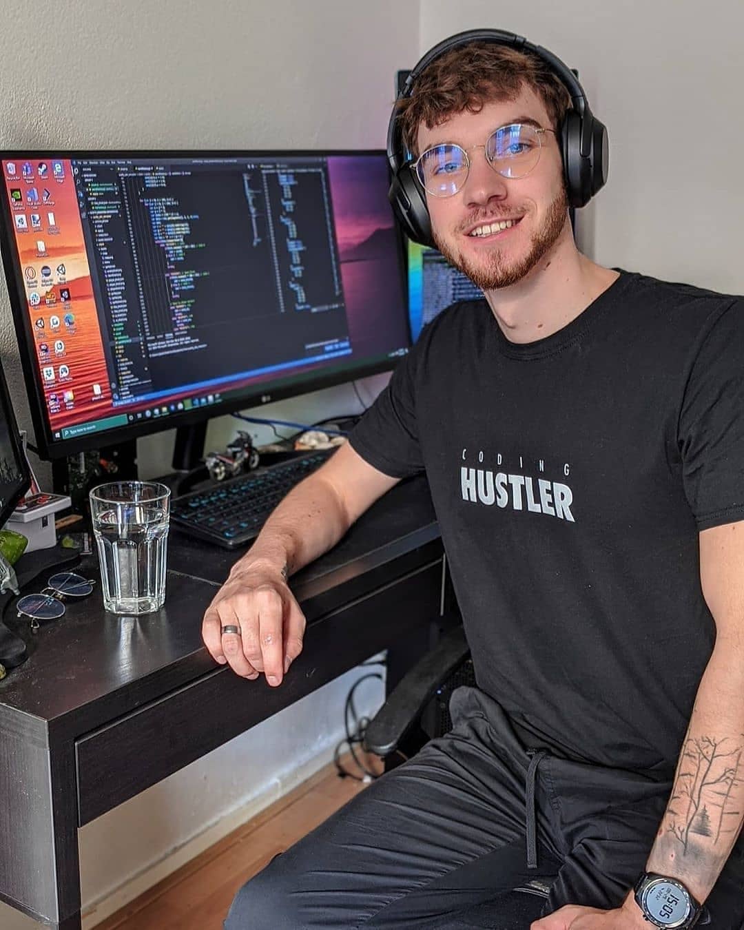 Justin wearing the Coding Hustler t-shirt by DevHero