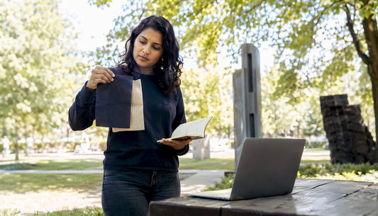 Woman examining sustainable fabrics at home desk